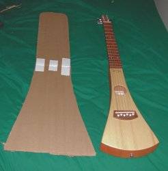 Dry bag material template beside guitar