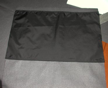 Internal pocket on the back side to hold the stiffener board.  Where the black nylon ends at the bottom is the transition from back to bottom.